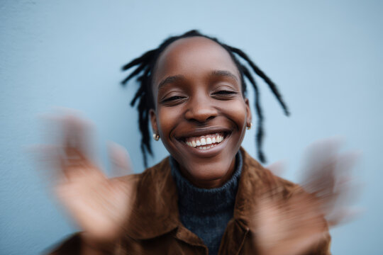 dynamic portrait of smiling individual displaying random emotion against soft pastel background