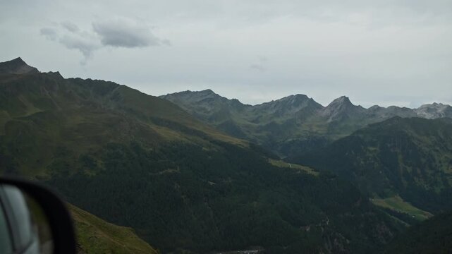 View from the car window of the alpine mountains landscape in Tyrol, Austria. Travel and tourism in Europe,
