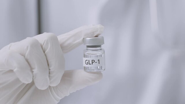 Professional doctor wearing white glove on hand holds medical vial offering scientific medicine dose treatment option for patient starting healthy weight loss journey with care
