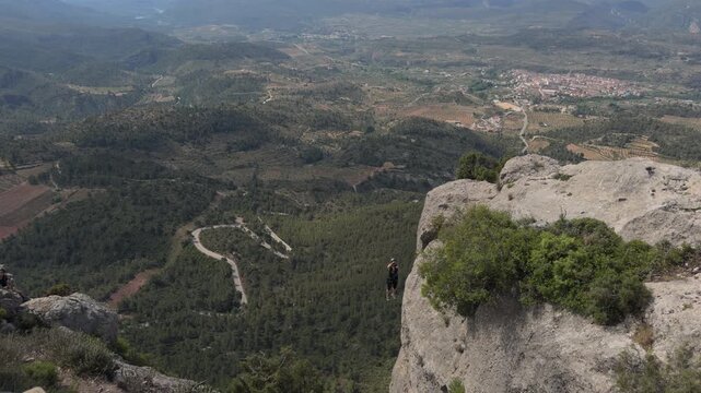 Aerial View of Via Ferrata Climber Above Forested Mountain Valley