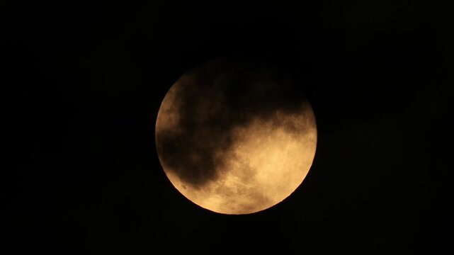 Video of the full moon coming out from behind the cloud	
