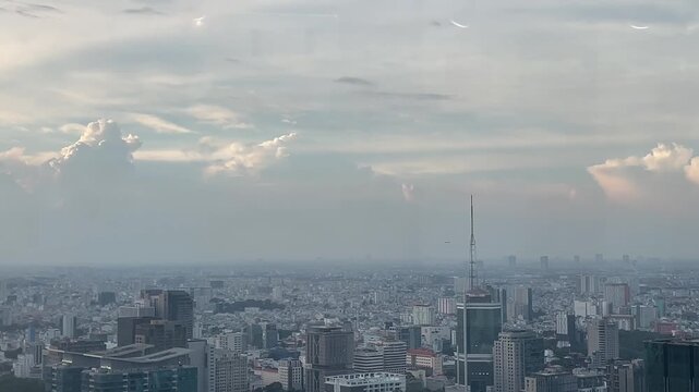 Expansive view of a city with a plane barely visible in the distance.