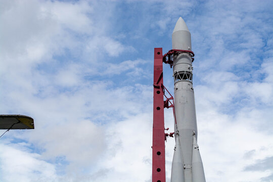 Space rocket on launch pad against blue sky. Tall aerospace vehicle stands ready for mission. Engineering masterpiece for exploration of deep universe. Technology and science transport.