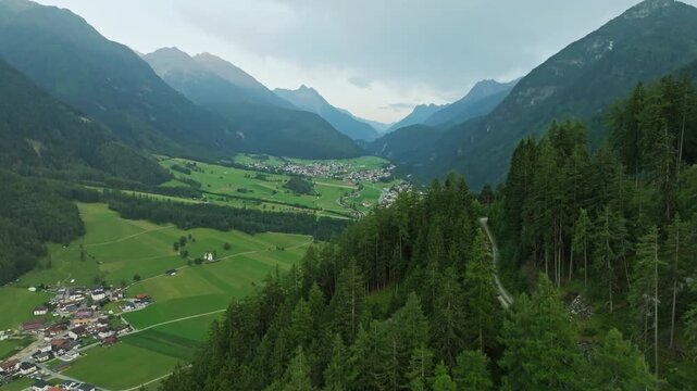 Beautiful aerial view of charming alpine villages nestled in Tyrol valleys surrounded by forested mountains spectacular scenery and tourism in Europe