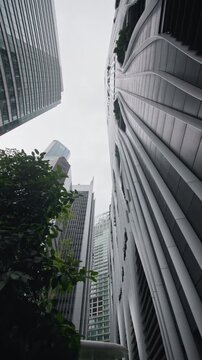 Cityscape of Singapore financial district featuring contemporary skyscrapers green public spaces modern business architecture and urban travel destination in Asia