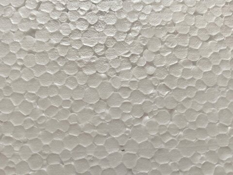 Macro close-up of white expanded polystyrene foam texture. Great for packaging concepts, insulation materials, industrial backgrounds, abstract textures, and design resources.
