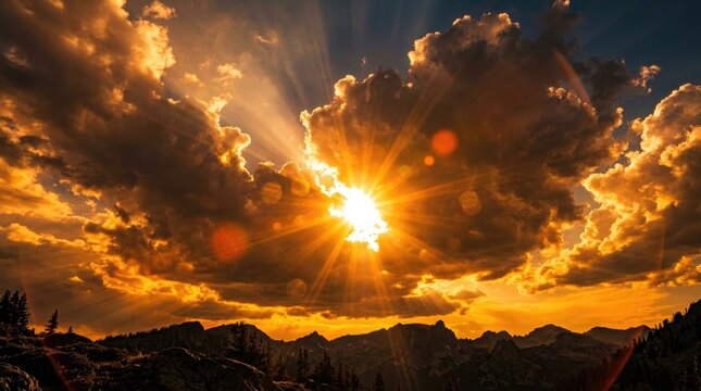 Sunset over mountain range with clouds and sun rays
