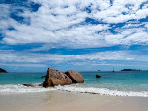 A beautiful beach with the typical rock formations of the Seychelles off the coast of Praslin Island.