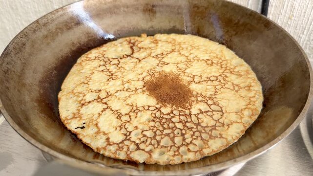 Finnish Pancake Frying in Pan on Stove