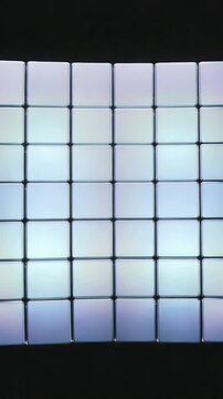 Vertical video: Lifting columns moving glossy cube array into ring on black void, fracturing core