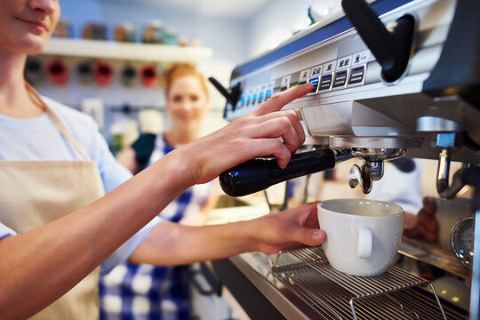 Female barista making coffee at a cafe
