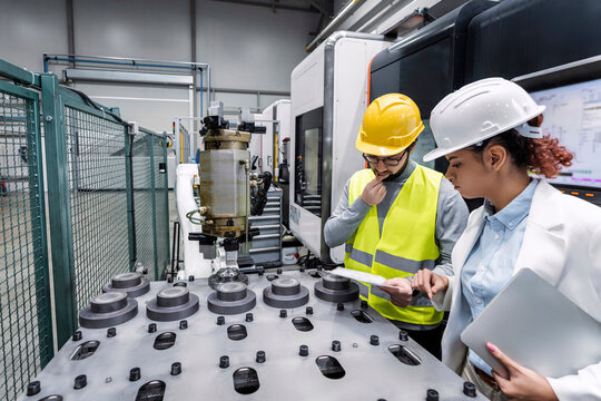 Engineer and colleague checking quality in factory