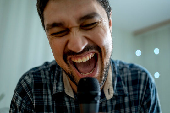 Happy man singing at home