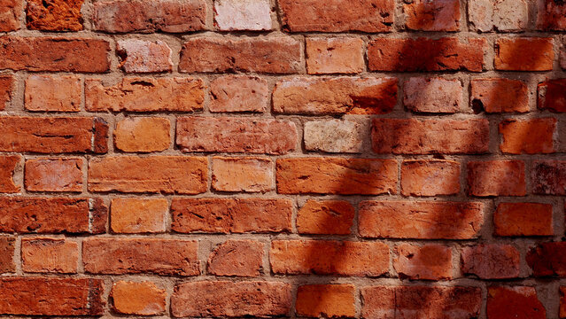 Red brick wall texture, background with leaf shadow, orange brickwork surface for architecture and interior design concepts