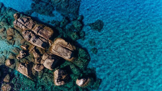 Aerial view reveals rock formation in the turquoise sea of Sardinia