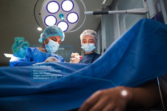 Man and woman perform hologram surgery in an operating room