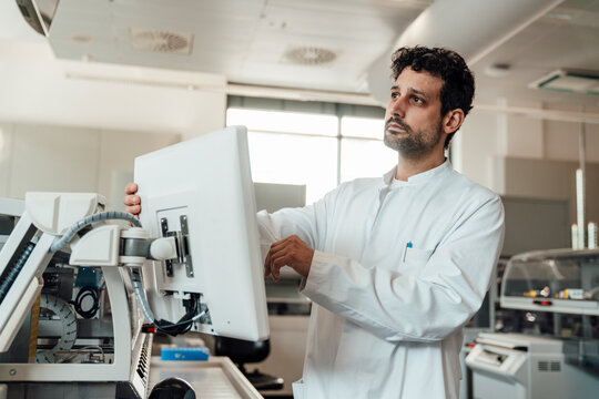 Scientist analyzing data on a display in a high-tech laboratory