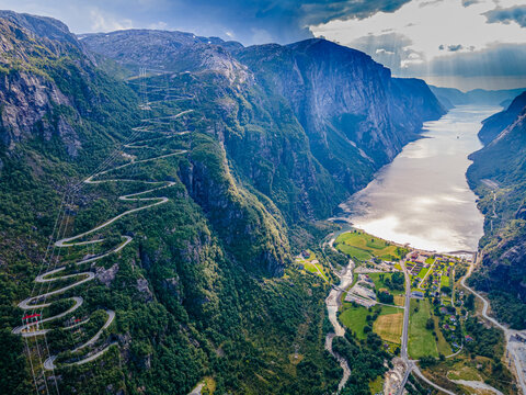 Norway, Rogaland, Lysebotn, Aerial view of winding road and coastal village at end of Lysefjord
