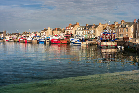 Fishing boat floats in the harbor of Barfleur at sunrise