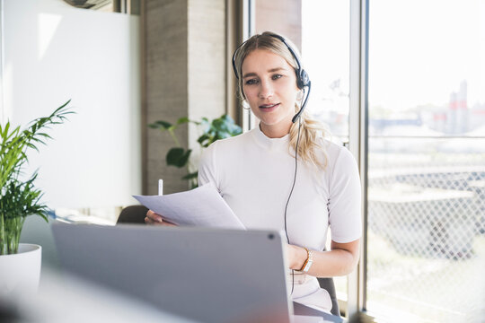 Customer service representative with document working in office