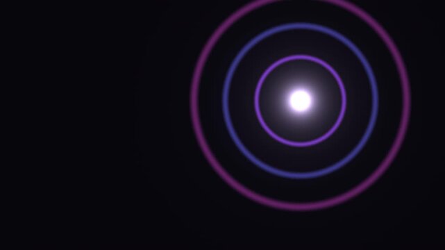 Bright circles of light on black background create a visual pattern