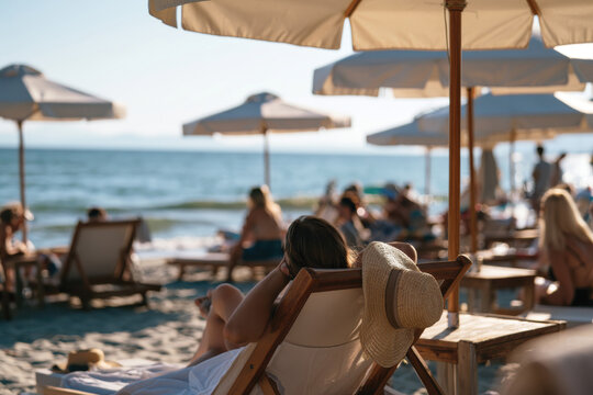 A serene view of a beach scene showcasing people lounging under various umbrellas, enjoying the sun, and appreciating the ocean's beauty on a perfect day.