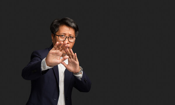 Mature Woman Making Stop Gesture with Raised Hands
