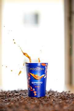 M&ouml;venpick Espresso iced coffee with dramatic coffee splash and roasted coffee beans &ndash; editorial
