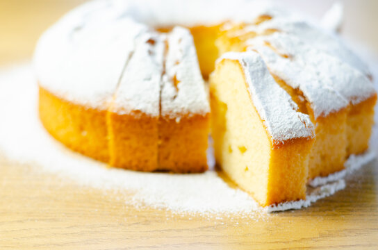 Golden cake dusted with powdered sugar sits invitingly