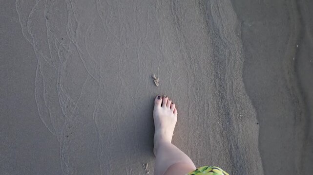 POV First-Person View of Barefoot Woman Walking on Sandy Beach