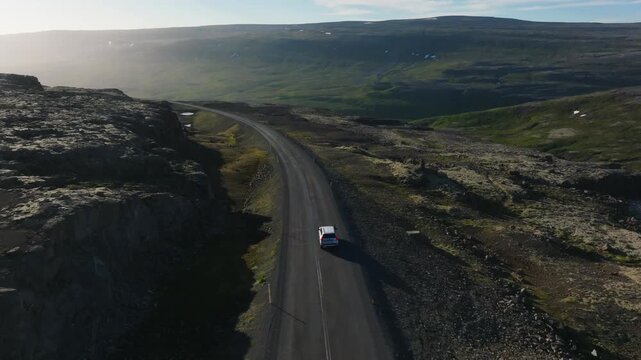 Aerial Drone Tracking Vehicle Drive Through Remote Westfjords Landscape Iceland Near Tungurif Golden Beach