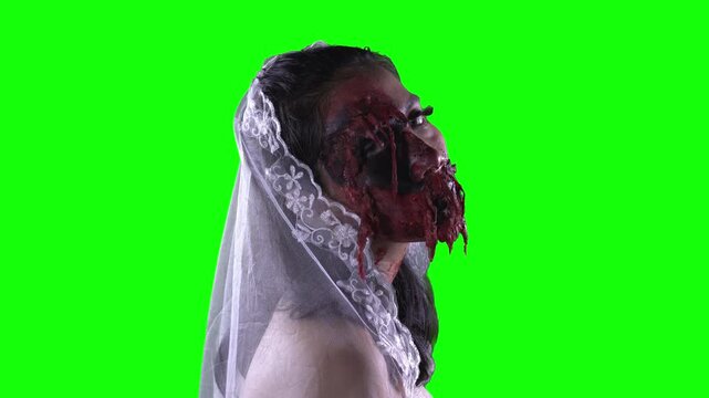 Creepy Zombie Bride Turning Face to Look at Camera on Green Screen