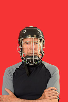 Male hockey player portrait wearing a black helmet with a metal face cage