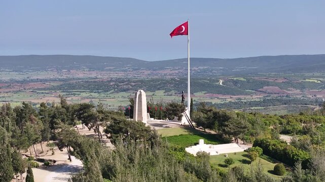 Aerial view of the Canakkale Martyrs' Memorial and cemetery with the Turkish Flag waving, oe01