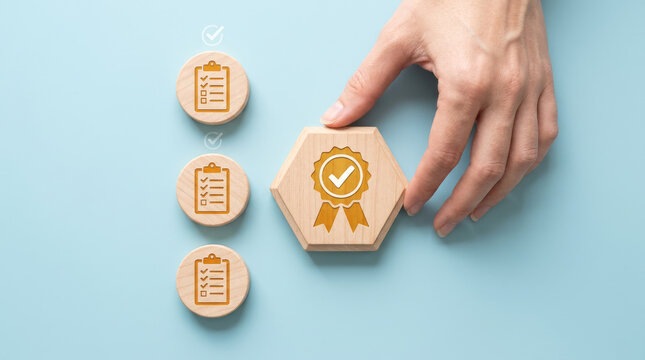 Quality assurance concept with hand placing wooden block, standard compliance checklist, certification and business evaluation process