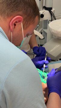 woman in dentistry tooth filling injection anesthesia. modern dental treatment with local anesthesia rubber dam filling procedure suction and bite check during professional tooth restoration