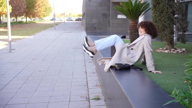 A woman enjoys a relaxing moment outdoors in a modern setting that offers comfort