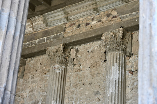 Two Engaged Columns with Fluted Shafts under the Portico of the Pompeii Basilica Framed by Two Out of Focus Exterior Columns