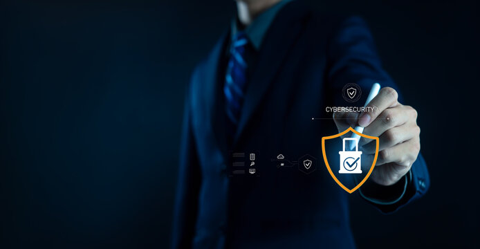 Businessman working on laptop with digital shield lock icon and Data Protection text, representing cybersecurity, data privacy, secure network, online safety, and information protection technology.