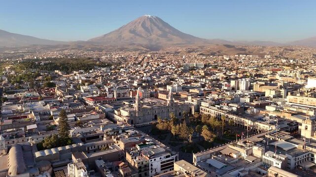 An aerial panning shot rotates to the right over Arequipa, Peru, tracking across the historic city center with El Misti volcano dominating the background.