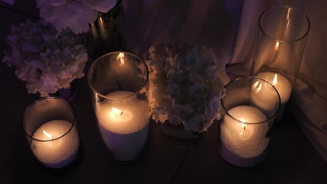 Beautiful glass vases with burning candles. Boho rustic decor. decorations for festive wedding ceremony