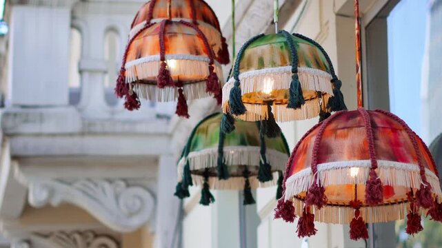 Ornate vintage boho pendant lamps with colorful fabric fringe and tassels.