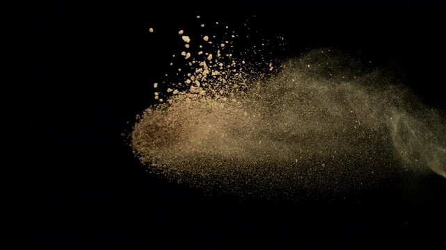 Super Slow Motion Shot Flying Soil Isolated on Black at 1000fps.
