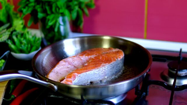 Step by step pan fried salmon steak recipe with fresh trout fillet seasoning oil and golden crust cooking process in black frying pan for homemade seafood meal
