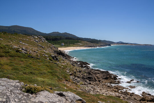 Prehistoric Celtic ruins of Castro de Baro&ntilde;a in Porto do Son, Galicia, Spain. Ancient Iron Age circular stone houses and fort fortress on a rocky coast peninsula facing the blue Atlantic Ocean.