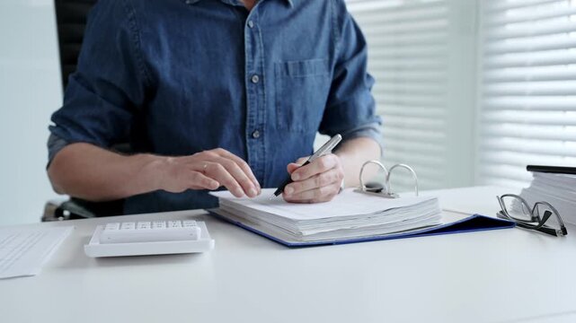 Man analyzing financial documents and calculating taxes, handling a large pile of paperwork and budgeting personal finance for business accounting or administrative tasks