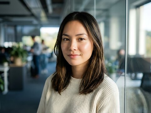 Professional woman smiling in modern office setting.