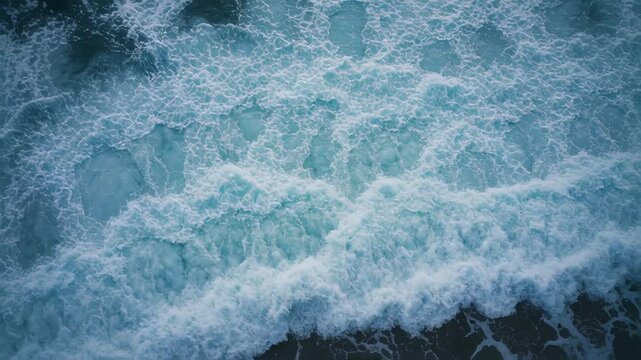 Swell arriving, ocean breaking into crests and swirling troughs overhead at coast with whitewater