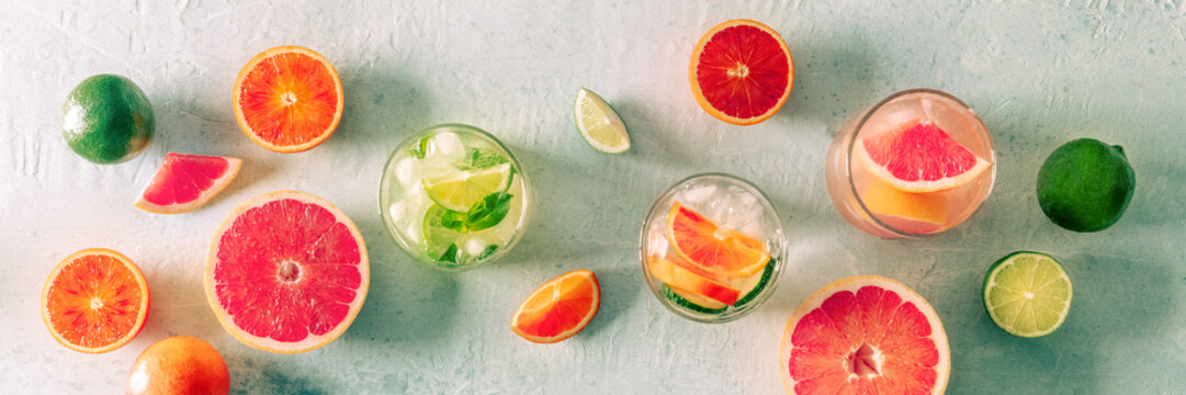 Refreshing summer cocktails with ice cubes on a light background