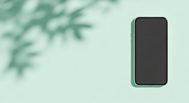 Minimalist Smartphone Mockup on Mint Green Background with Soft Leaf Shadows for App Presentation and Web Design